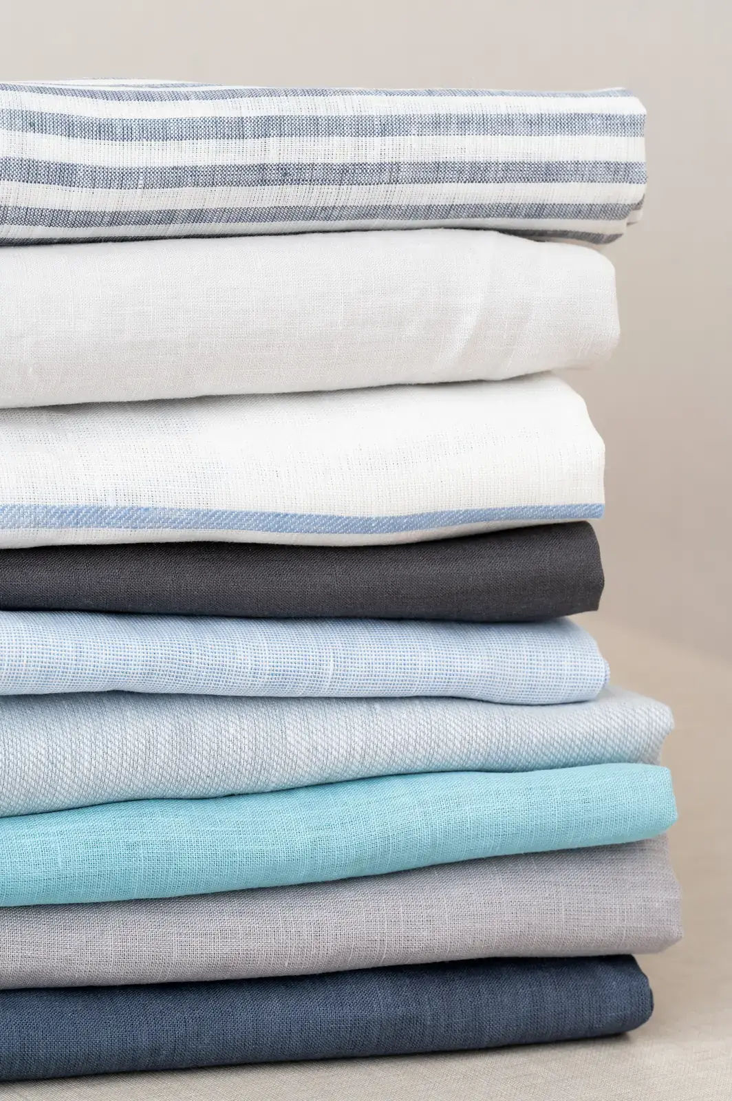 Linen samples stacked by colour